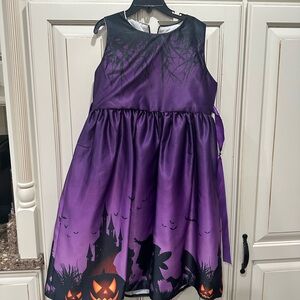 Girls Halloween dress or witch costume size 150 or 12. Comes with purple hat.